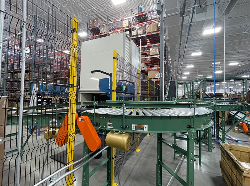 Image of Aisleguard industrial safety railing within a factory protecting a conveyor.